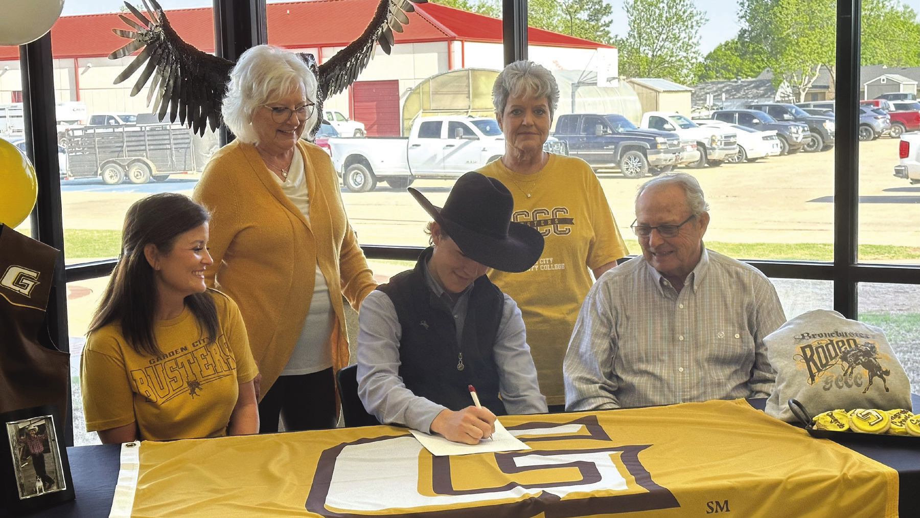 ◄ Creek Williams, center, signs with Garden City, Kansas, Community College for rodeo. He is pictured with family. Pictured is, front row, from left, Kelsey Williams and Dan Knight. Back row are Donna Knight and Debbie Shepherd. Tyler Bryson/WDN