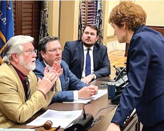 From left: senate Appropriations and Budget Chairman Roger Thompson, R-Okemah, vice chairman Chuck Hall, RPerry, and deputy director of fiscal staff Will Robinson speak with senate minority leader Kay Floyd, D-Oklahoma City, following a committee meeting March 13. Tres Savage/nondoc.com