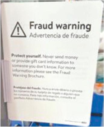 in Washington, D.C., displays signs at its checkout counters to warn consumers about gift card fraud. Barbara Barrett/Stateline