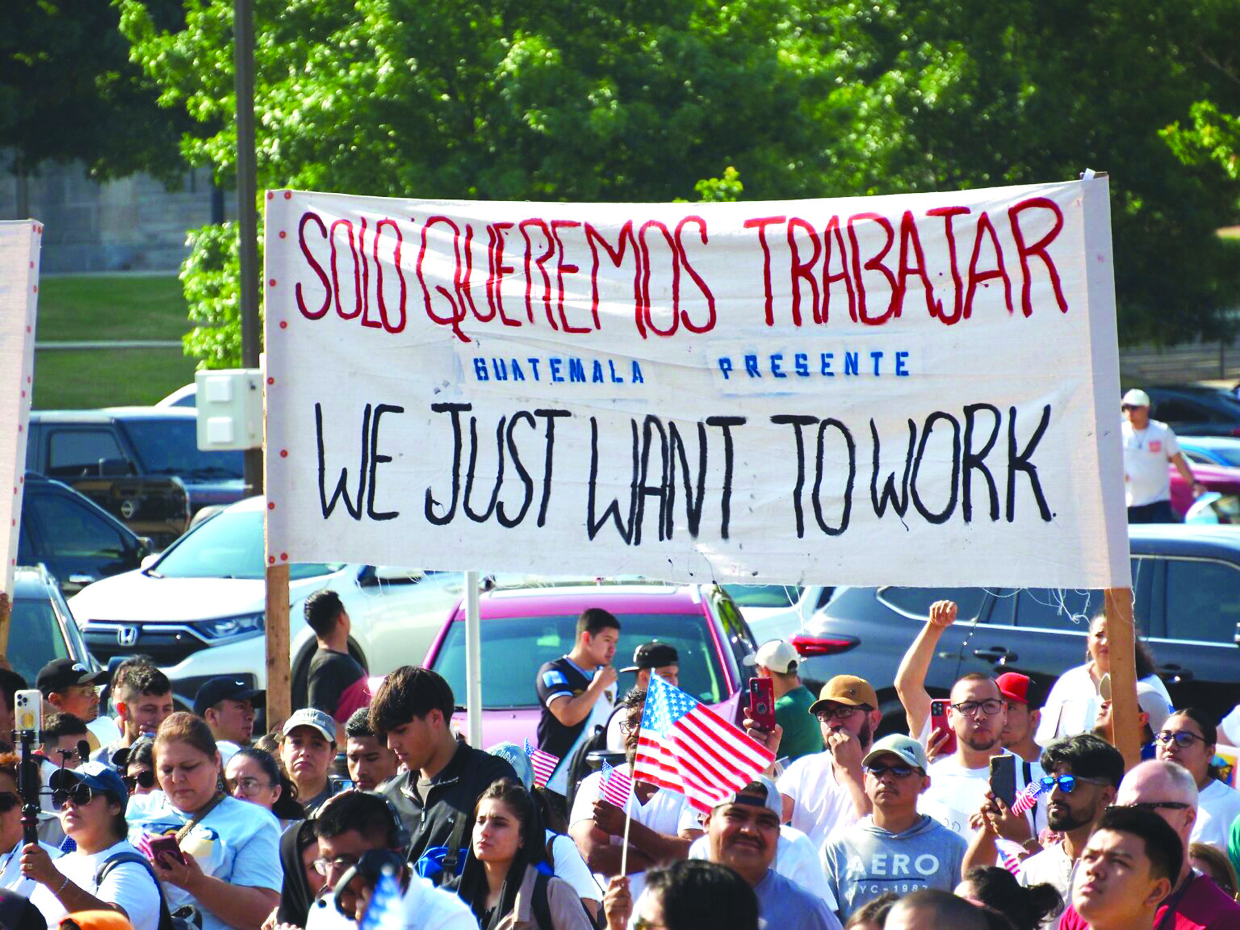 Guatemalan Oklahomans hold a sign in Spanish and English which reads, “We just want to work” at a Hispanic Cultural Day rally outside the Oklahoma State Capitol May 15. Hundreds of people, most of them Latino, protest the newly enacted House Bill 4156, which creates the criminal offense of impermissible occupation. Nuria Martinez-Keel/Oklahoma Voice