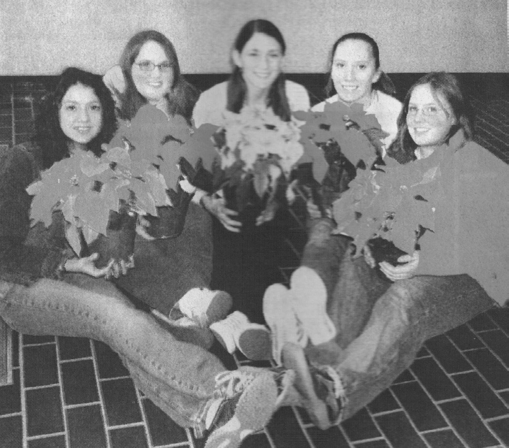 Weatherford High School students, from left, Lupita Moreno, Hayley Vogt, Cierra Musick, Miranda Blackwell and Sarah Dahlgren display the red, pink and white poinsettias they are delivering as a choir class fundraiser.
