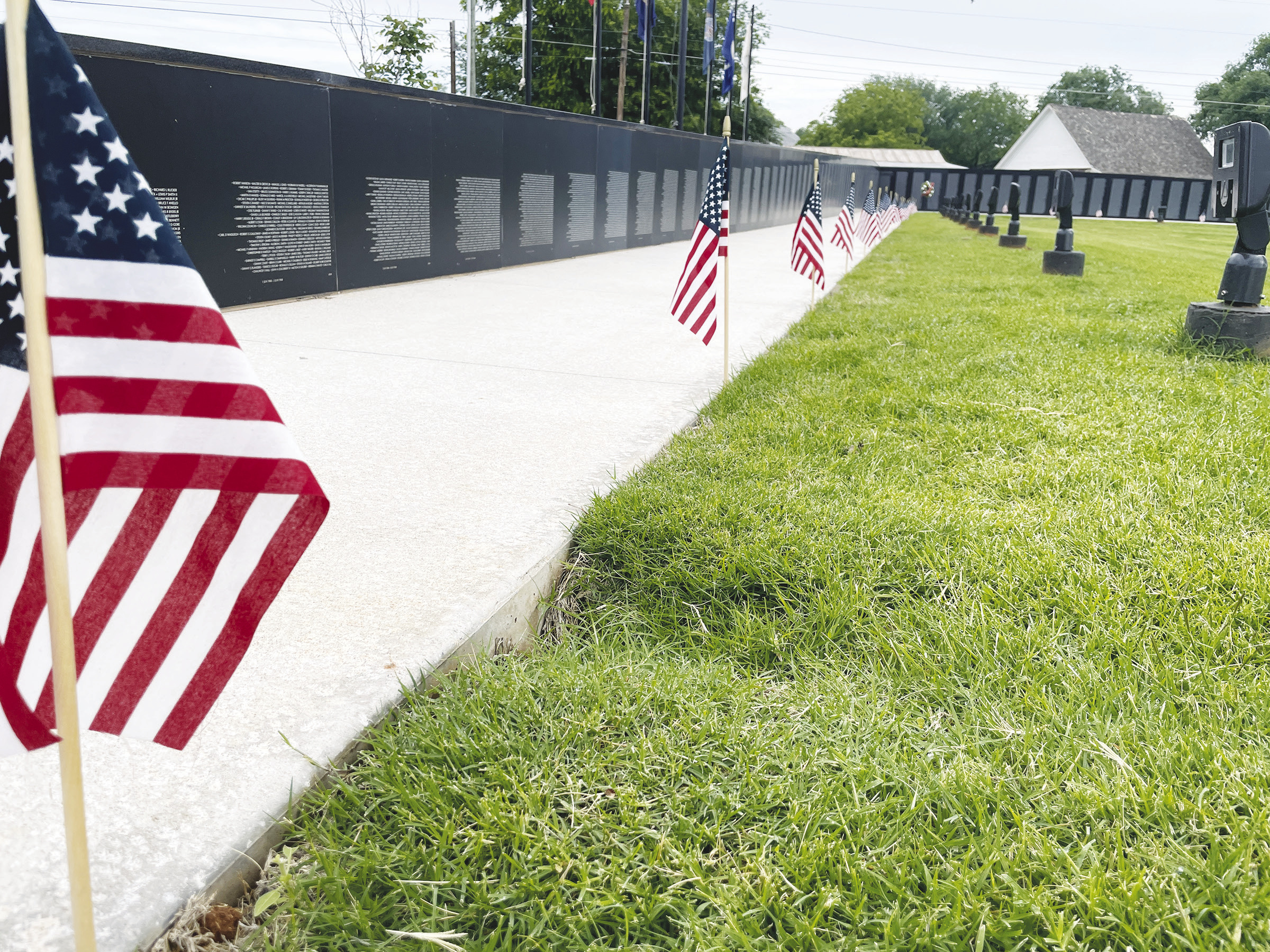 ◄ Flags were placed along the Vietnam Veterans Memorial Wall to commemorate fallen soldiers for Memorial Day. Montgomery Malone/WDN