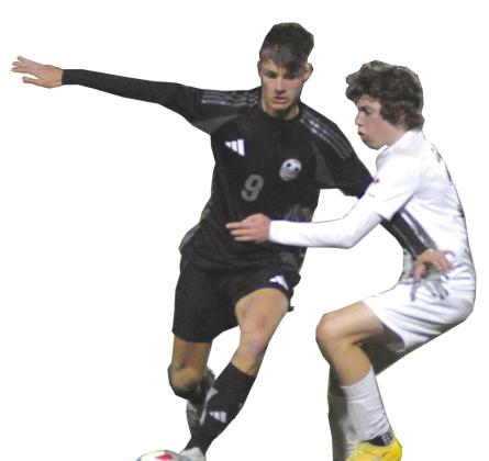 Carson Allen tries to avoid a defender against Oklahoma Christian School. The boys soccer team finished second in the district standings. Josh Burton/WDN